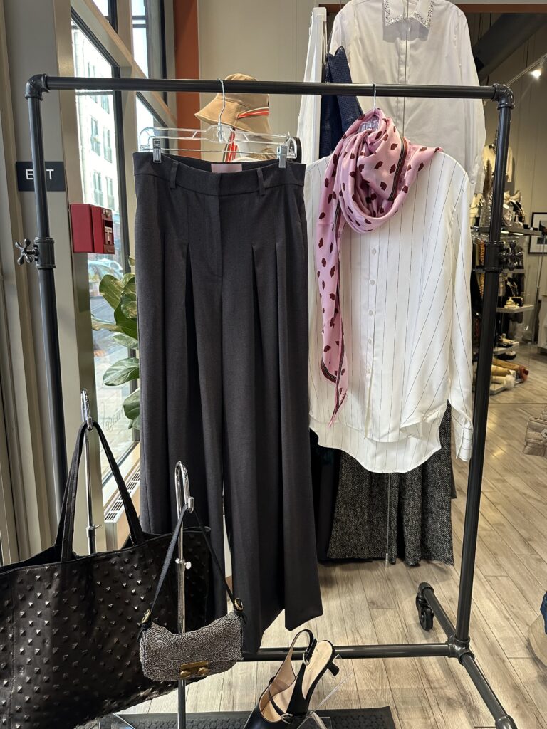 Seasonal capsule wardrobe with mix-and-match outfits displayed on a clothing rack