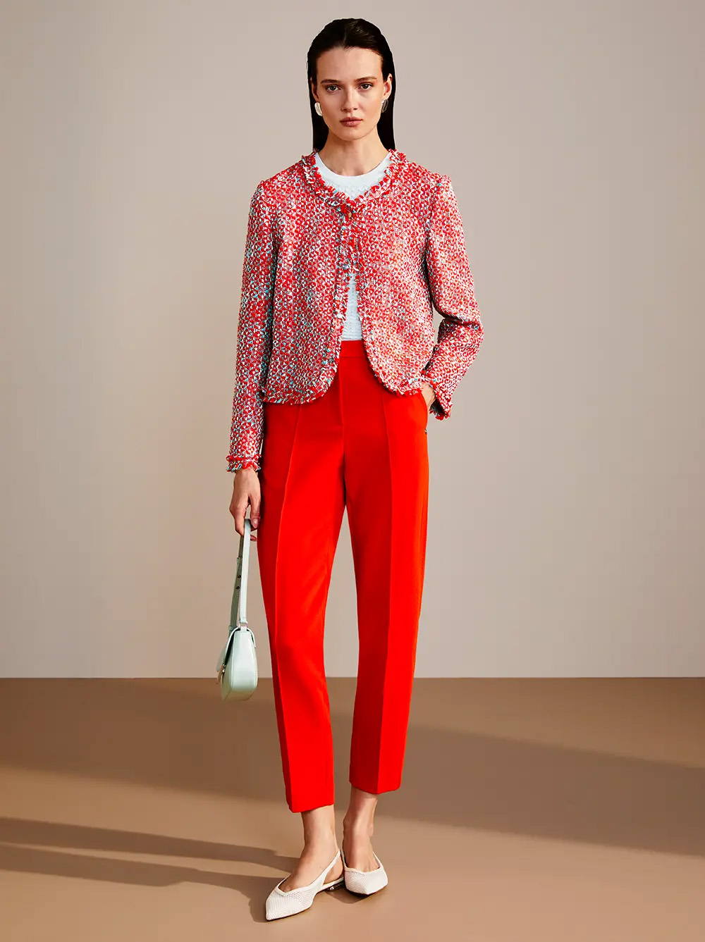 Marc Cain red Woman in red sweater and red trousers shows tailored fit and confidence.
