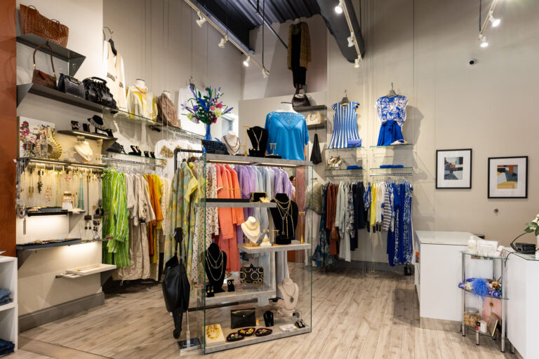 A center rack with lighting near clothing racks in women's boutique in Carmel Indiana.