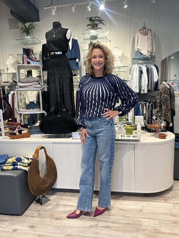Boutique store owner can dress up or down with a blue and white striped shirt and jeans.